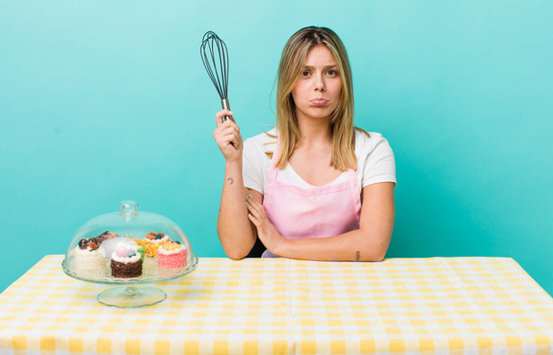 pretty blonde woman feeling sad and whiney with an unhappy look and crying. homemade cake concept - Photo, Image