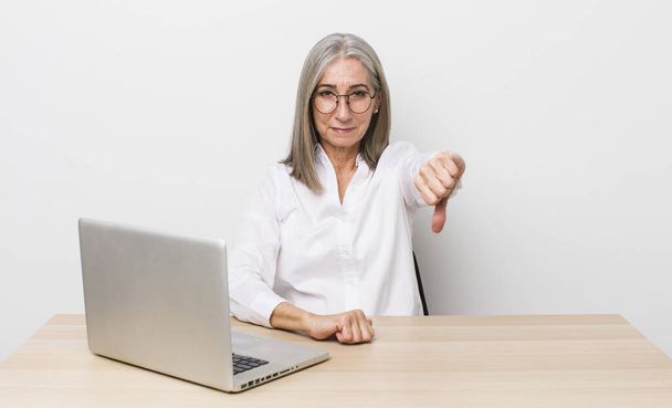 senior  gray hair woman feeling cross,showing thumbs down. desk and business concept - Φωτογραφία, εικόνα