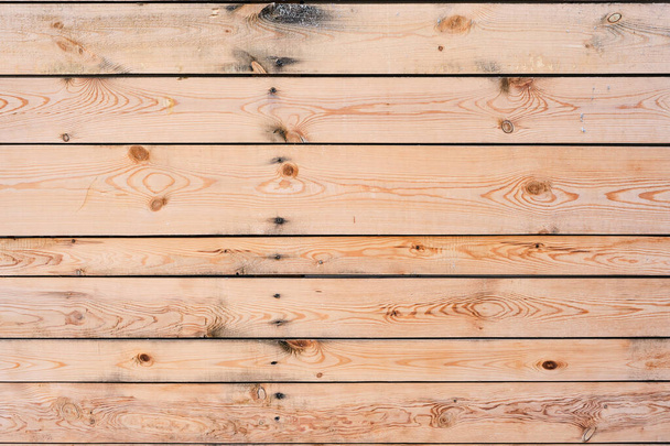 Wooden background of horizontal pine boards covered with knots - Foto, Bild