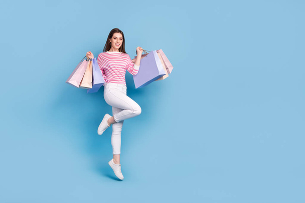 Full body portrait of excited satisfied person hold packages isolated on blue color background - Φωτογραφία, εικόνα