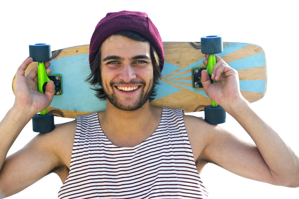 Skateboarder holding  skateboard behind  head. - Φωτογραφία, εικόνα