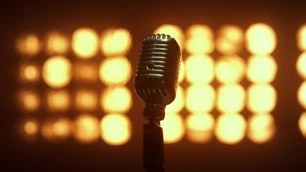 Retro mic placed empty scene illuminated lamps close up. Microphone in nightclub - Footage, Video