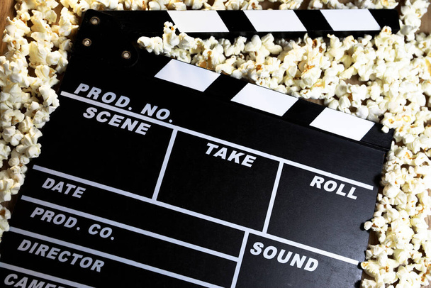 clapperboard for film shooting, with popcorn you feel more like going to the cinema - Photo, image