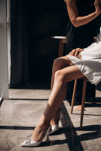 bride's legs in elegant shoes close-up - Фото, изображение