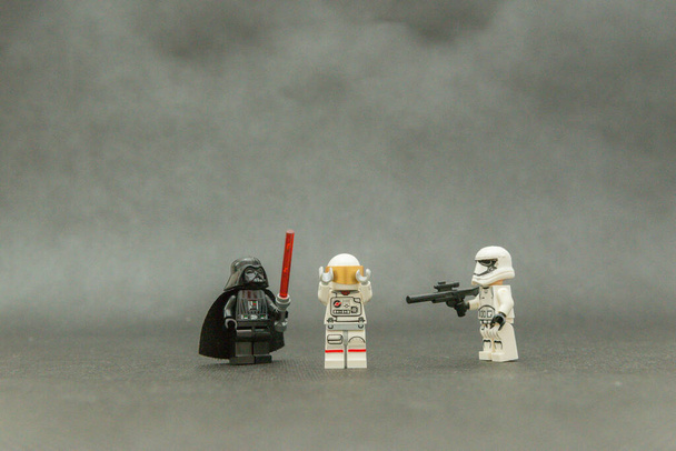 Bauru, Brazil. September, 15, 2019: Darth Vader and a Stormtrooper rendering an astronaut lost in space. Evil over good. Lego minifigures are manufactured by The Lego Group. - Foto, Imagen