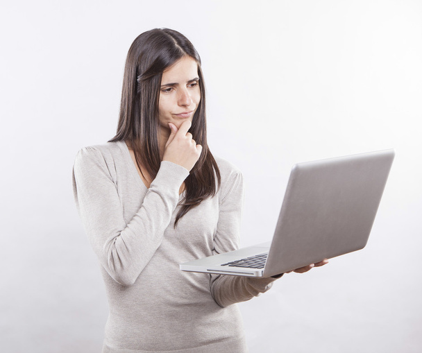 beautiful young woman using a laptop computer - Zdjęcie, obraz