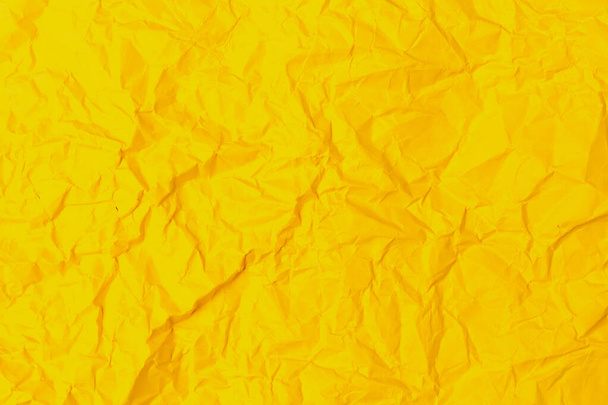 レトロな古いヴィンテージの古典的なグランジペーパーのラフなしわの質感の表面。背景や背景。設計は空白だ。純粋な黄色またはほとんど純粋な黄色 - 写真・画像
