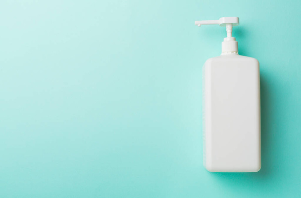 Hand sanitizer in white bottle on color background. - Foto, imagen