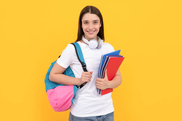 smiling lady in headphones hold copybook carry backpack, knowledge - Fotoğraf, Görsel