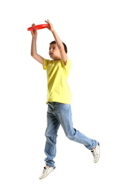 Funny little boy playing frisbee on white background - Foto, afbeelding