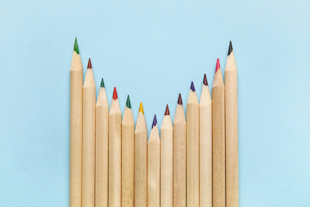 Colorful pencils on blue background - Foto, afbeelding