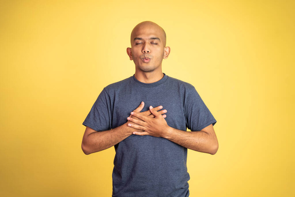 bald man holding chest and closing eyes feeling comfortable - Φωτογραφία, εικόνα