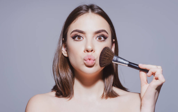 Cute girl with makeup and blusher brush. Cosmetics product concept. - Photo, Image