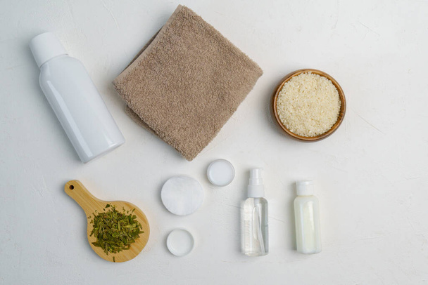 Skin care, a mock-up of a bottle with a dispenser, rice and green tea, the concept of fermented beauty care. Flat lay - Fotoğraf, Görsel
