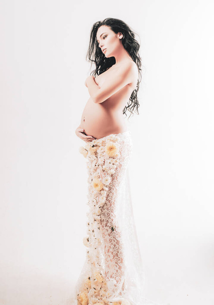 pregnancy. Maternity preparation. womens health. girl with big belly. future mother have baby inside. life birth expectation. Love. beautiful pregnant woman in spring flower skirt. Waiting for a baby - Фото, изображение