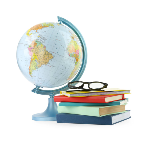 Plastic model globe of Earth, books and eyeglasses on white background. Geography lesson - 写真・画像