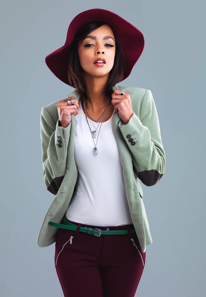 Stay classy. Studio portrait of a stylish young woman posing against a gray background. - Fotografie, Obrázek