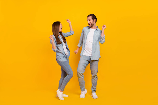 Full length body size view of attractive cheerful funky people dancing having fun isolated over bright yellow color background - Foto, Bild