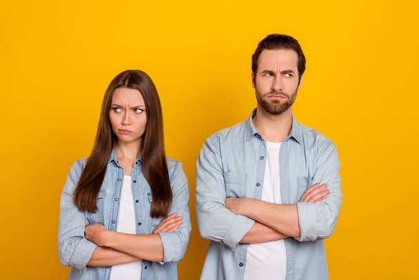 Photo of sad young brown hairdo couple crossed arms look promo wear jeans shirts isolated on yellow background - Fotó, kép