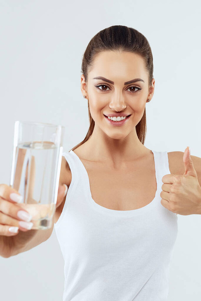 Water glass. Beautiful girl hold water. White background isolated. Drink water. Diet concept - Photo, image