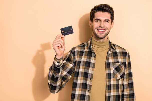 Photo of positive economy worker showing debit card income profit earnings isolated pastel color background - Foto, imagen
