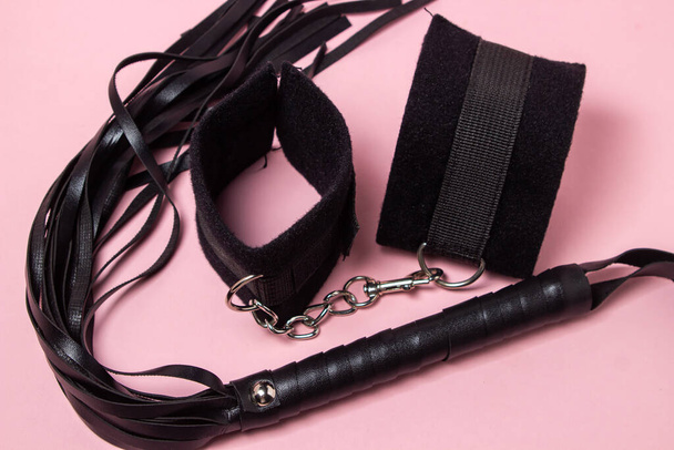 BDSM accessories on a pink background. Toys for adults. Sex accessories - Foto, imagen