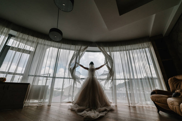 View of bride from the back, romantic atmosphere of the bride's morning. Elegant wedding dress. - Photo, image