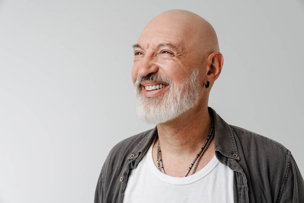 Bald european man with beard laughing and looking aside isolated over white background - Foto, Imagem