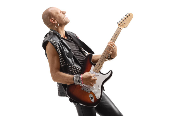 Profile shot of a rocker playing an electric guitar isolated on white background - Foto, Imagen