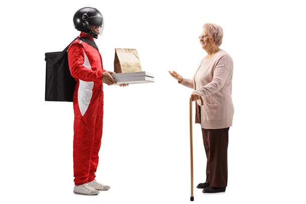 Food delivery man with a helmet delivering pizza to an elderly woman isolated on white background - Foto, immagini