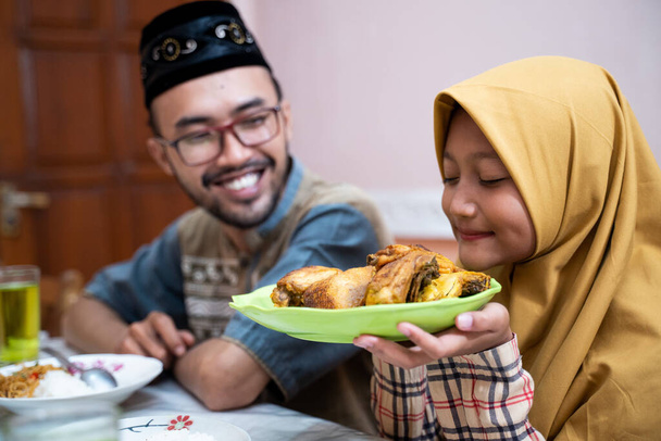 muslim father and daughter during iftar dinner on ramadan kareem - Foto, Bild