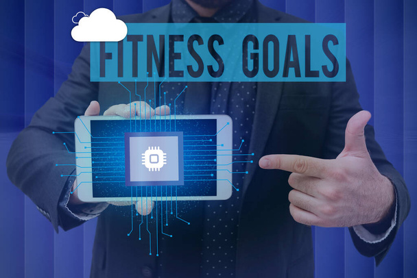Writing displaying text Fitness Goals. Business concept Loose fat Build muscle Getting stronger Conditioning Man holding Screen Of Mobile Phone Showing The Futuristic Technology. - Photo, Image