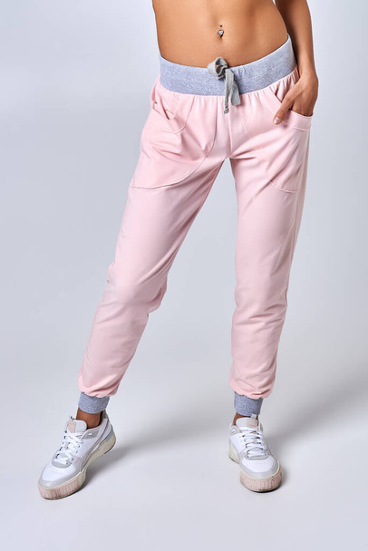 Legs of a young girl in bright sweatpants - Foto, Bild