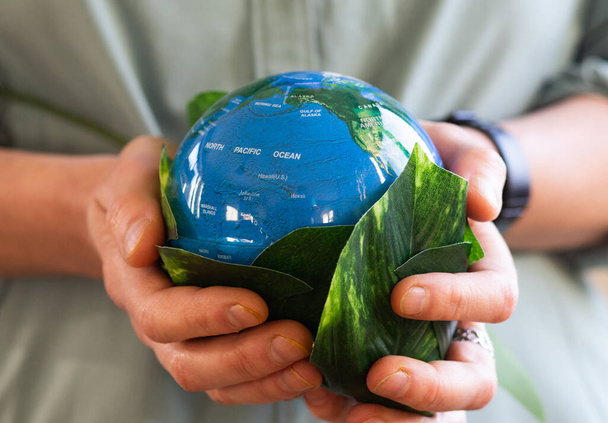 hand holding globe environment esg concept - Фото, изображение