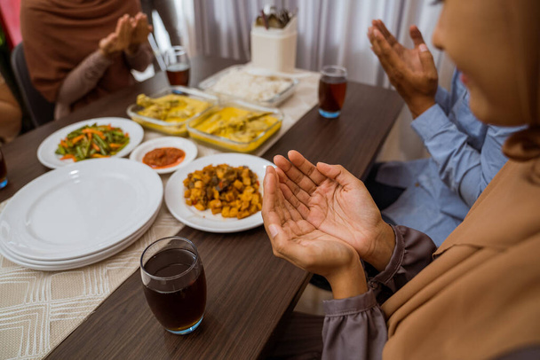 muslim people praying before break fasting iftar dinner together - Foto, immagini