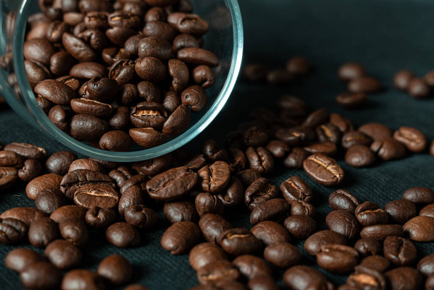 roasted coffee beans on a wooden background - Фото, зображення