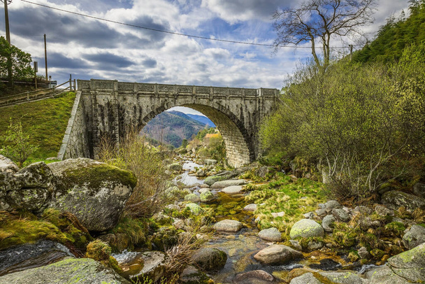 bridge over the river in the mountains - Фото, изображение