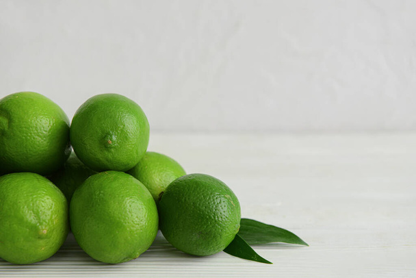 Pile of fresh limes on table, closeup - Photo, Image