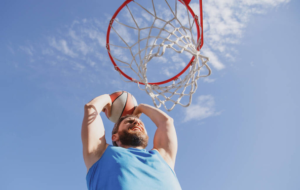 American basketball player scoring a slam dunk. - Фото, зображення