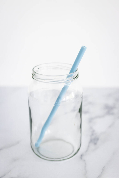 upcycled glass jar with silicon straws instead of plastic container and straws, concept of zero waste and environmentally conscious choices - Photo, Image