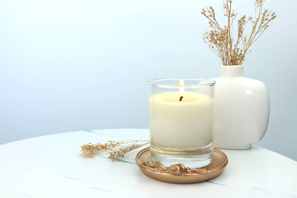 luxury aroma lighting aromatic scented candle glass displayed on white table with white cement wall background to creat romantic and relax ambient on valentine day - Photo, image