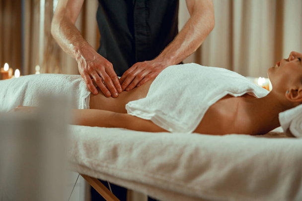 Alternative medicine male therapist doing relaxing massage to female client - 写真・画像