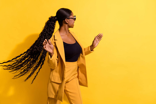 Profile side view portrait of attractive cheerful girl throwing hair dancing having fun good mood isolated on bright yellow color background - Zdjęcie, obraz