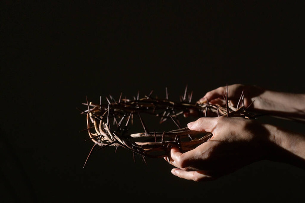 Closeup Crown of thorns in hands and sun rays - Фото, зображення