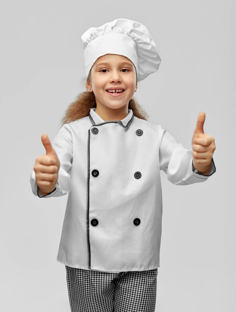 little girl in chefs toque showing thumbs up - Foto, Imagem