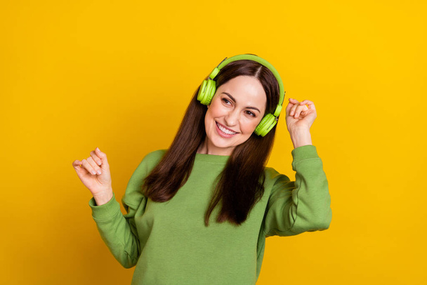 Portrait of attractive cheerful woman listening single dancing moving rest relax isolated over bright yellow color background - Fotó, kép