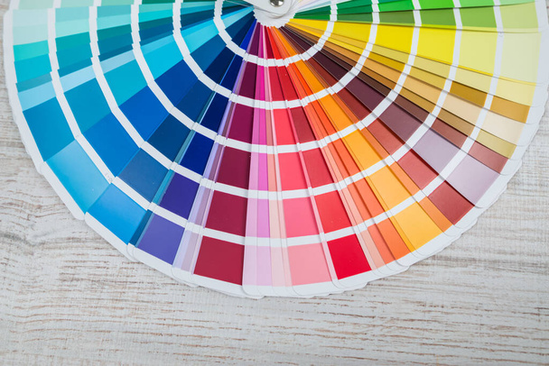 Color palette guide on wooden background. Catalog of color samples. - Photo, Image