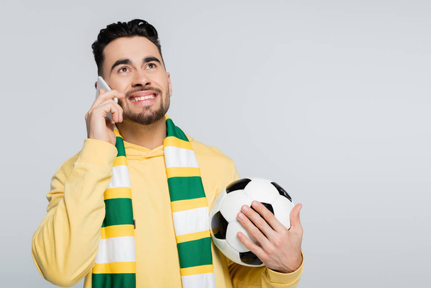 happy football fan talking on smartphone isolated on grey - Photo, Image