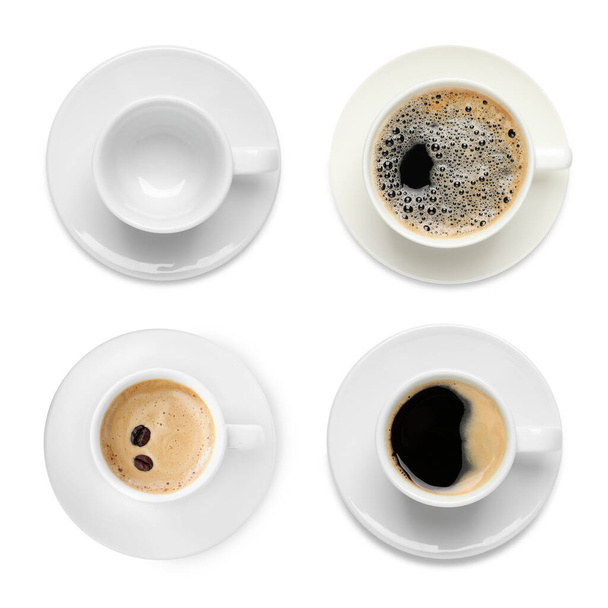Set of cups with aromatic hot coffee and empty one on white background, top view - 写真・画像