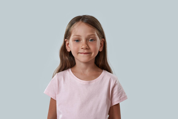 Partial of serious little girl looking at camera - Foto, Imagen